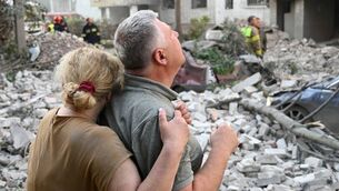 <p>Local residents react outside a residential building partially destroyed as a result of Russian missile strikes in the western Ukrainian city of Lviv on July 30. Picture: Yuriy Dyachyshyn / AFP via Getty Images.</p>