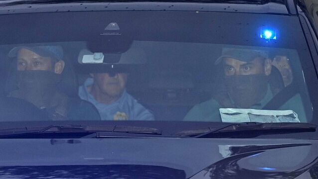<p>Daniel Kinahan (back, right) leaving the Criminal Courts of Justice in Dublin on Sunday, where he was remanded in custody charged with directing an organised crime group, after being extradited from Dubai. Photo: Mark Marlow/PA</p>