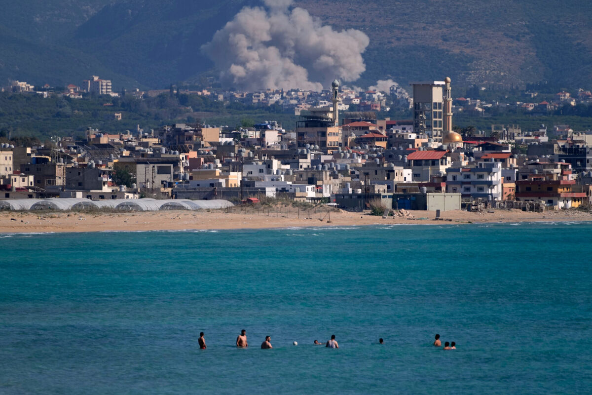 People swim on a public beach as smoke, background, rises from an Israeli airstrike that hit the Qlaileh village, seen from the southern port city of Tyre, Lebanon, Tuesday, June 2, 2026. (AP Photo/Mohammed Zaatari) People swim on a public beach as smoke, background, rises from an Israeli airstrike that hit the Qlaileh village, seen from the southern port city of Tyre, Lebanon, Tuesday, June 2, 2026. (AP Photo/Mohammed Zaatari)