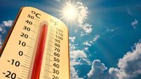 low angle view Thermometer on blue sky with sun shining