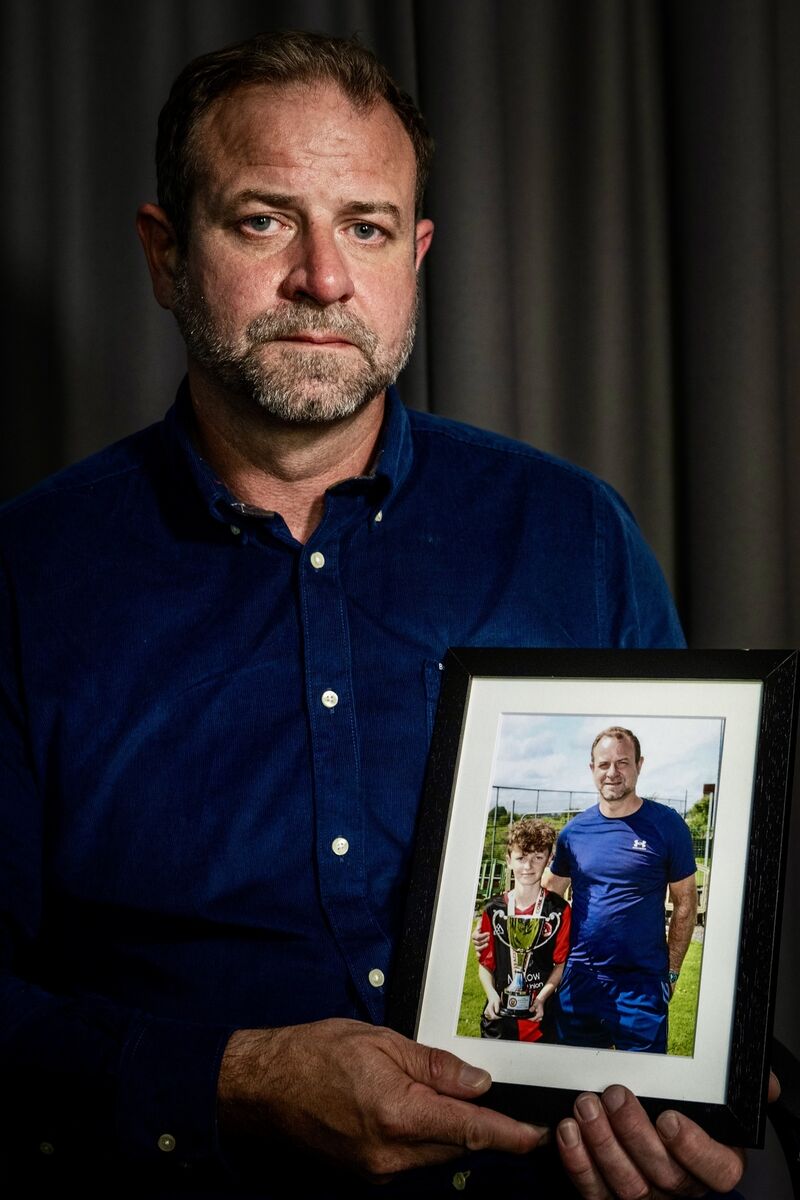 Craig Coady holds a photograph of himself and Rory celebrating a sporting success. Craig says Rory’s memory gives him the strength to continue fighting for access to treatment for his surviving son, Paudie. Picture: Chani Anderson Craig Coady holds a photograph of himself and Rory celebrating a sporting success. Craig says Rory’s memory gives him the strength to continue fighting for access to treatment for his surviving son, Paudie. Picture: Chani Anderson