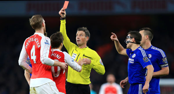 Arsenal's Per Mertesacker is shown the red card by referee Mark Clattenburg during the Barclays Premier League match at the Emirates Stadium, London. Arsenal's Per Mertesacker is shown the red card by referee Mark Clattenburg during the Barclays Premier League match at the Emirates Stadium, London.