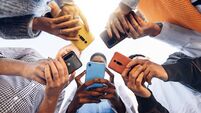 Teens in circle holding smart mobile phones - Multicultural young people using cellphones outside - Teenagers addicted to new te