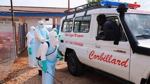 Health workers disinfect an ambulance at Ebola Treatment Centre at Bunia General Hospital in Ituri (Dirole Lotsima Dieudonne/AP)