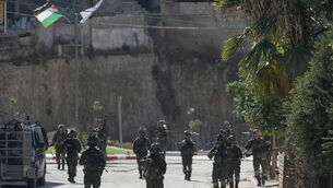 Israeli army soldiers patrol the streets of the occupied West Bank village of Qusra (Majdi Mohammed/AP)