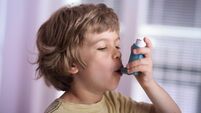 Boy using asthma inhaler to treat inflammatory disease, wheezing, coughing, chest tightness and shortness of breath. Allergy tre