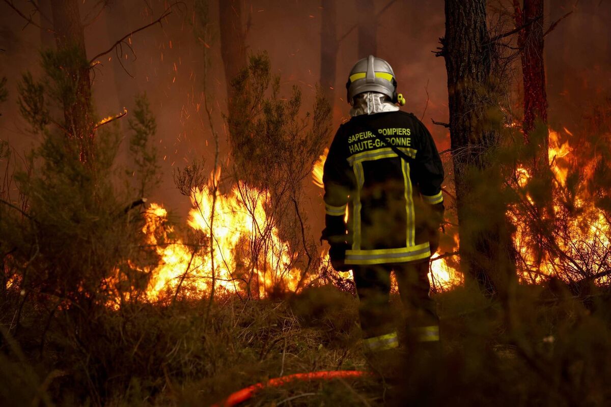  A firefighter stands before flames as a forest fire rages in Saint-Jean-d'Illac, some 30km from Bordeaux, on July 26, 2026 as a wildfire has been ravaging the forest north of the Arcachon Basin (Gironde). (Photo by ROMAIN PERROCHEAU / AFP via Getty Images)
