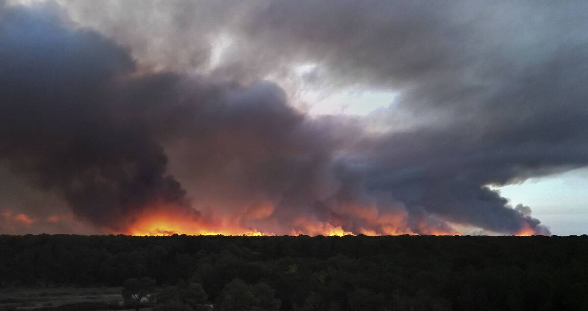 This aerial view shows a residential area engulfed in flames during a wildfire in the forest of Lege-Cap-Ferret, southwestern France on July 23, 2026, after residents were evacuated as the blaze threatened homes. (Photo by Olivier MORIN / AFP via Getty Images)