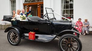 <p>Eileen and William travelled in style in a vintage Ford supplied by the groom's friend Billy Ryan. Pictures: Dermotsullivan.com</p>