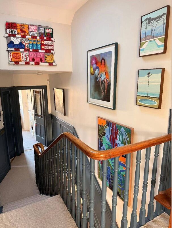 The stairway gallery wall features work by Asha Murray, Chloe Earley, Emma O'Hara and Michael Amery.