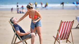 <p>Beachgoers apply sun factor during the hot summer. Moody's estimated that last summer's European heatwaves cost €43bn in lost economic output while generating only about €500m of insured payouts. Picture: PA</p>