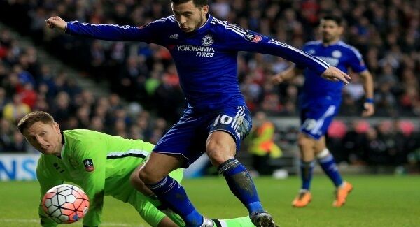 Eden Hazard and MK Dons goalkeeper David Martin contest for ball in the penalty area at Stadium:MK. Photos: Mike Egerton/PA
