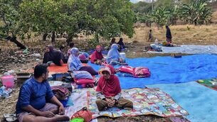 <p>Residents of Nangahale village who had to spend the night in an open field in in Sikka, East Nusa Tenggara, after the magnitude 7.7 earthquake off Indonesia's eastern Flores island on Saturday. Picture: Arnold Welianto/AFP/Getty</p>