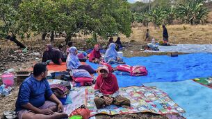 <p>Residents of Nangahale village who had to spend the night in an open field in in Sikka, East Nusa Tenggara, after the magnitude 7.7 earthquake off Indonesia's eastern Flores island on Saturday. Picture: Arnold Welianto/AFP/Getty</p> <p>Residents of Nangahale village who had to spend the night in an open field in in Sikka, East Nusa Tenggara, after the magnitude 7.7 earthquake off Indonesia's eastern Flores island on Saturday. Picture: Arnold Welianto/AFP/Getty</p>