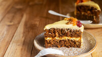 Slices of carrot cake with cream cheese frosting on a plate