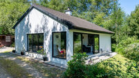 Inside a charming €285k Beara bungalow with lake views, woodland setting and a garden bar