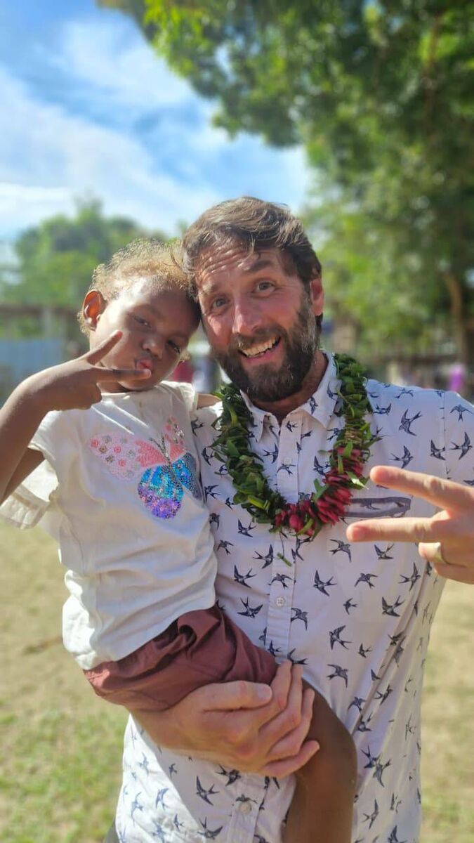 Maurice with Natalie, a child from a World Vision supported community on the Solomon Islands. Maurice with Natalie, a child from a World Vision supported community on the Solomon Islands.