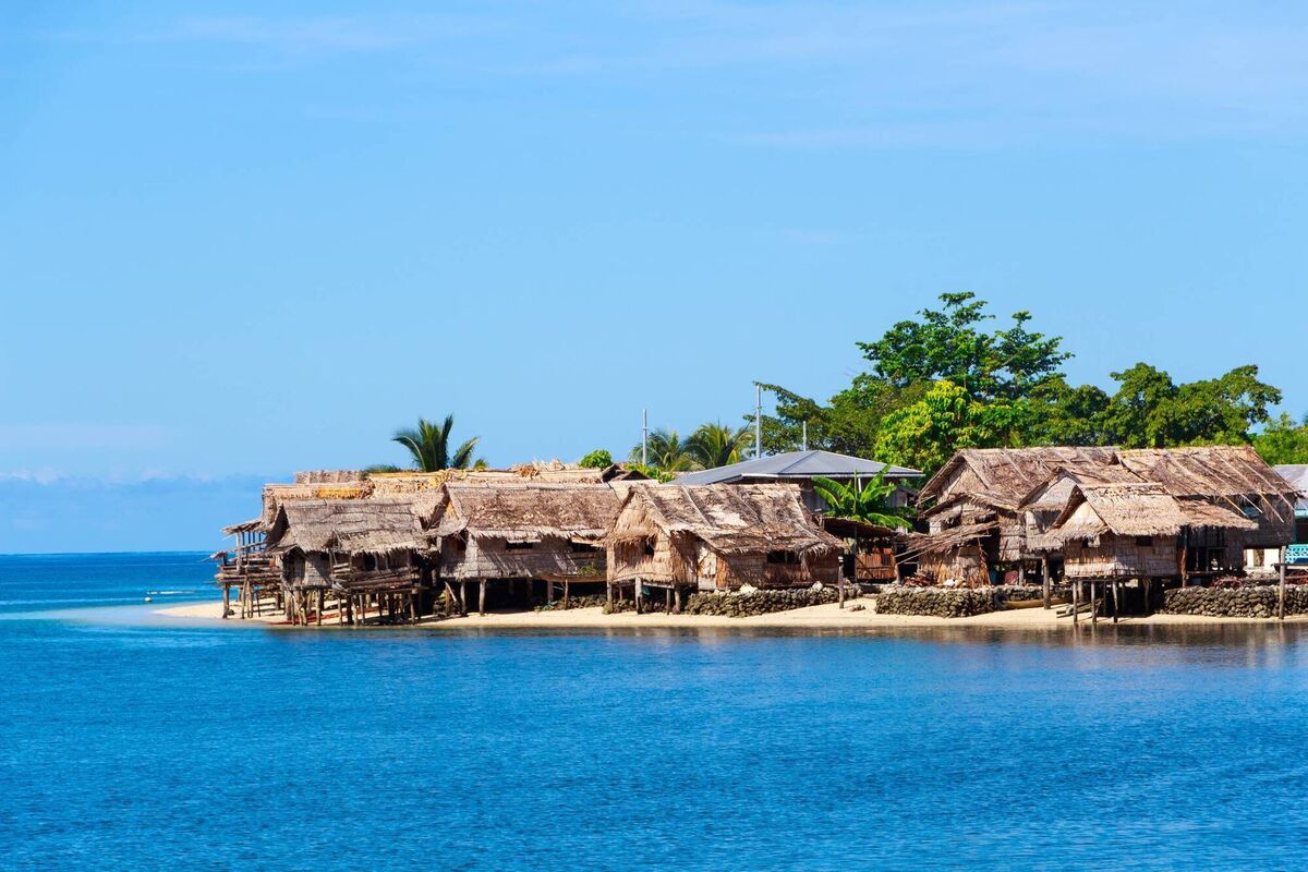 Traditional thatched houses on a beach in Auki, the provincial capital of Malaita Province, Solomon Islands. Traditional thatched houses on a beach in Auki, the provincial capital of Malaita Province, Solomon Islands.