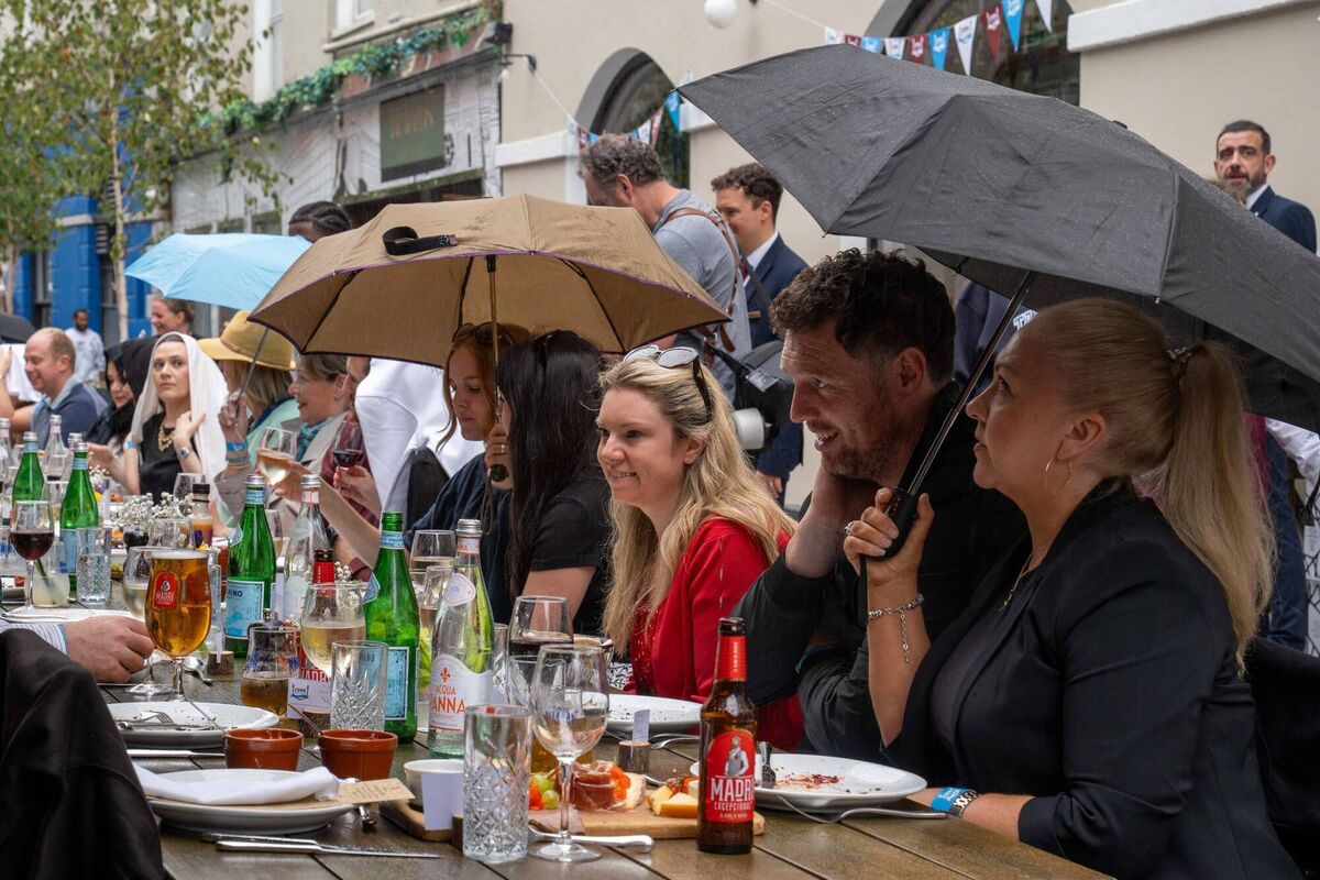 A shower of rain failed to dampen the spirits of diners at the Pembroke Street long table. Picture: ThaliaGreaux. A shower of rain failed to dampen the spirits of diners at the Pembroke Street long table. Picture: ThaliaGreaux.