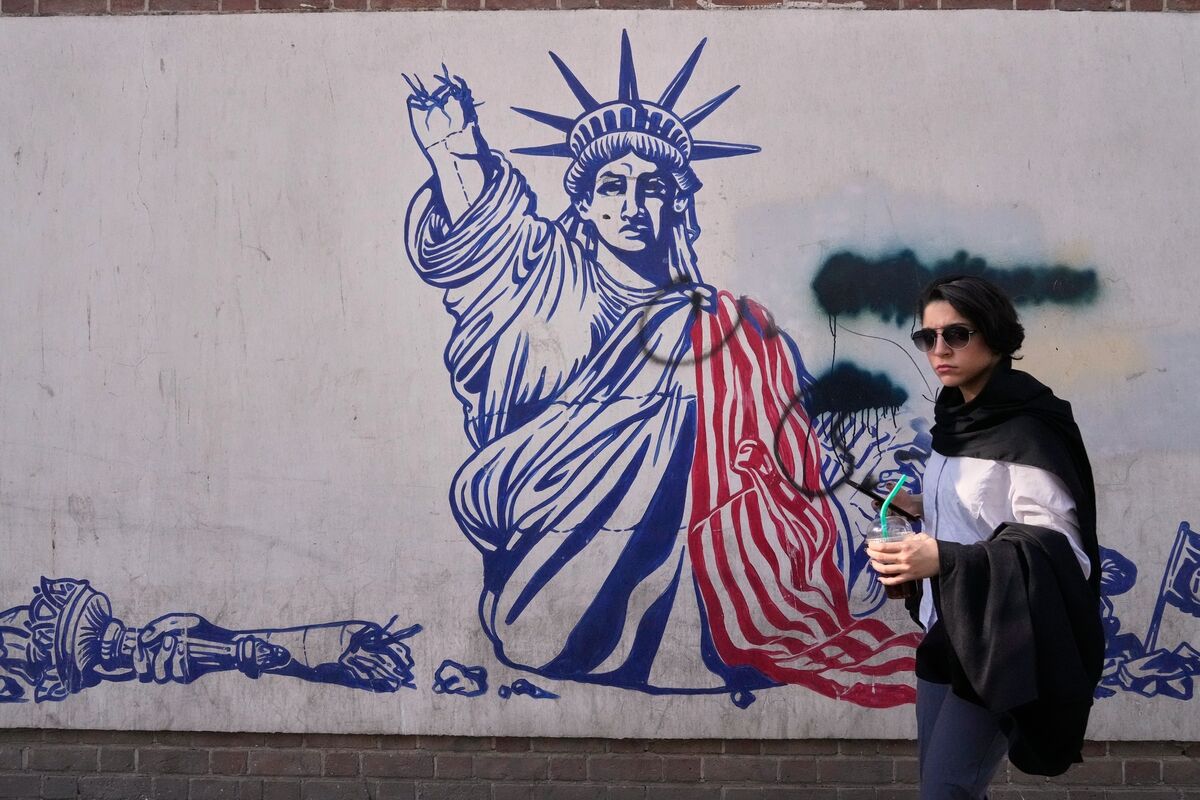 A woman walks past an anti-American mural on the wall of the former U.S. Embassy, now a museum, in Tehran, Iran. (AP Photo/Vahid Salemi) A woman walks past an anti-American mural on the wall of the former U.S. Embassy, now a museum, in Tehran, Iran. (AP Photo/Vahid Salemi)