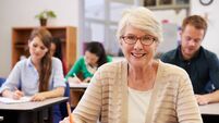 Happy senior woman at an adult education class looking