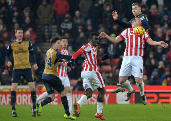 Stoke City's Charlie Adam and Arsenal's Calum Chambers battle for the ball in the air at the Britannia Stadium. Photo: Martin Rickett/PA