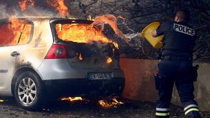 <p>A police officer tries to put off the fire in a car during a wildfire, in L'Estaque district of Marseille, southern France on July 8, 2025. Picture: CLEMENT MAHOUDEAU/AFP via Getty Images</p> <p>A police officer tries to put off the fire in a car during a wildfire, in L'Estaque district of Marseille, southern France on July 8, 2025. Picture: CLEMENT MAHOUDEAU/AFP via Getty Images</p>