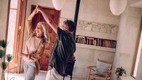 Happy mature couple dancing and celebrating together at home
