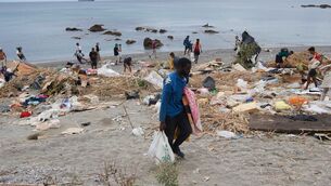 <p>Migrants who crossed from Morocco into Ceuta gather their belongings after being cleared from the beach (Antonio Sempere/AP)</p> <p>Migrants who crossed from Morocco into Ceuta gather their belongings after being cleared from the beach (Antonio Sempere/AP)</p>