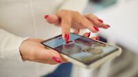 Hands of young female choosing boyfriend or possible husband in online dating application