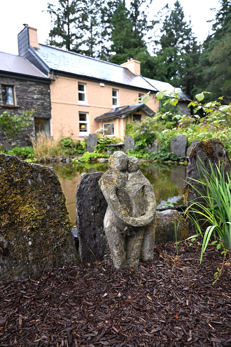 'Embracing couple' stone sculpture beside the pond 'Embracing couple' stone sculpture beside the pond