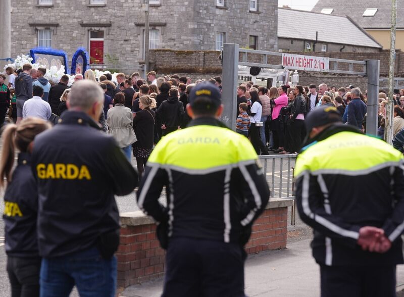 Members of the Garda stand outside St. Michael the Archangel Church in Athy as the funeral cortege for Joe Carthy, 15, arrives, one of the five teenagers who died in a horror motorway crash in Co Kildare last weekend. Picture: Brian Lawless/PA Wire
