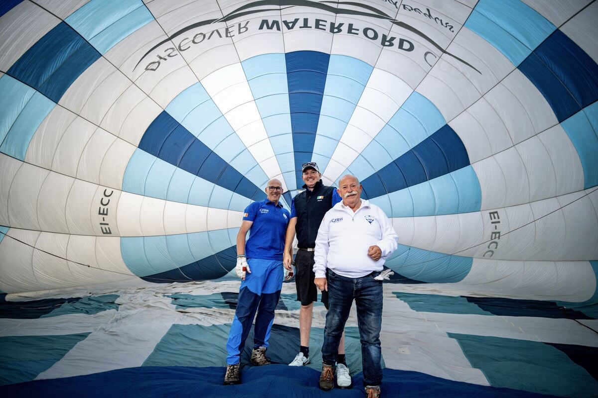 Hot air balloon pilots, father and son Joe and Zack Daly, with crew member Ray Leahy inside the balloon canvas as they prepare for take-off from Waterford Castle. Picture: Chani Anderson Hot air balloon pilots, father and son Joe and Zack Daly, with crew member Ray Leahy inside the balloon canvas as they prepare for take-off from Waterford Castle. Picture: Chani Anderson