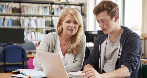 College Student Has Individual Tuition From Teacher In Library