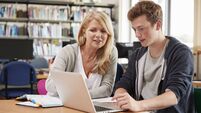 College Student Has Individual Tuition From Teacher In Library