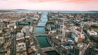 Dublin Ireland aerial view of river Liffey and city center, aerial view of Dublin skyline and Samuel Beckett Bridge, aerial view