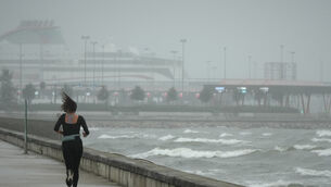 A jogger runs at the beach along the Tallinn bay of the Baltic Sea (Sergei Grits/AP)
