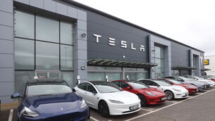 Cars on the forecourt of the Tesla dealership (PA)