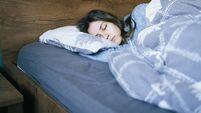 Young woman sleeping in bed at night