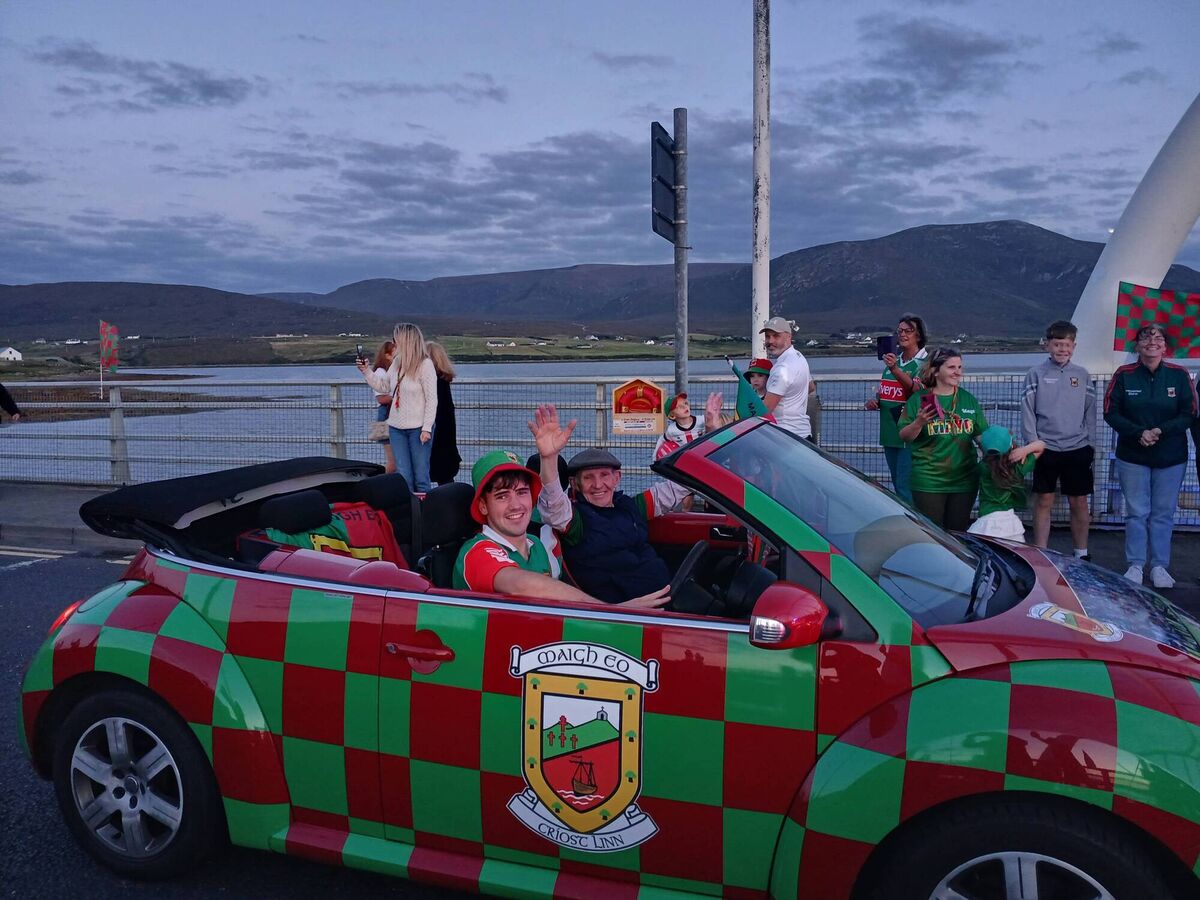 Seán Paul McNamara (driving) and Packie McGinty lead the procession onto Achill Island.