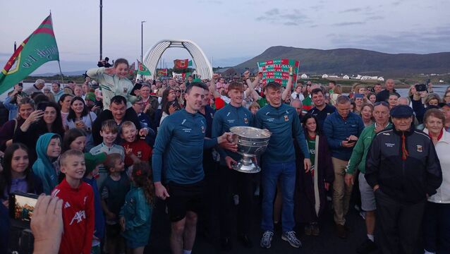 <p>All-Ireland champions Diarmuid O'Connor, Jack Carney, and Donnacha McHugh pictured after carrying Sam Maguire onto Achill Island. </p>