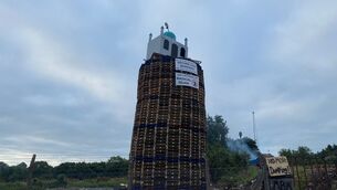 <p>A bonfire with a replica mosque, is built in Moygashel, Co Tyrone, ahead of events to mark the Twelfth July. File picture: Jonathan McCambridge/PA</p>