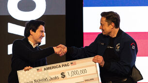 Elon Musk hands over a million dollar cheque (Jeffrey Phelps/AP) Elon Musk hands over a million dollar cheque (Jeffrey Phelps/AP)