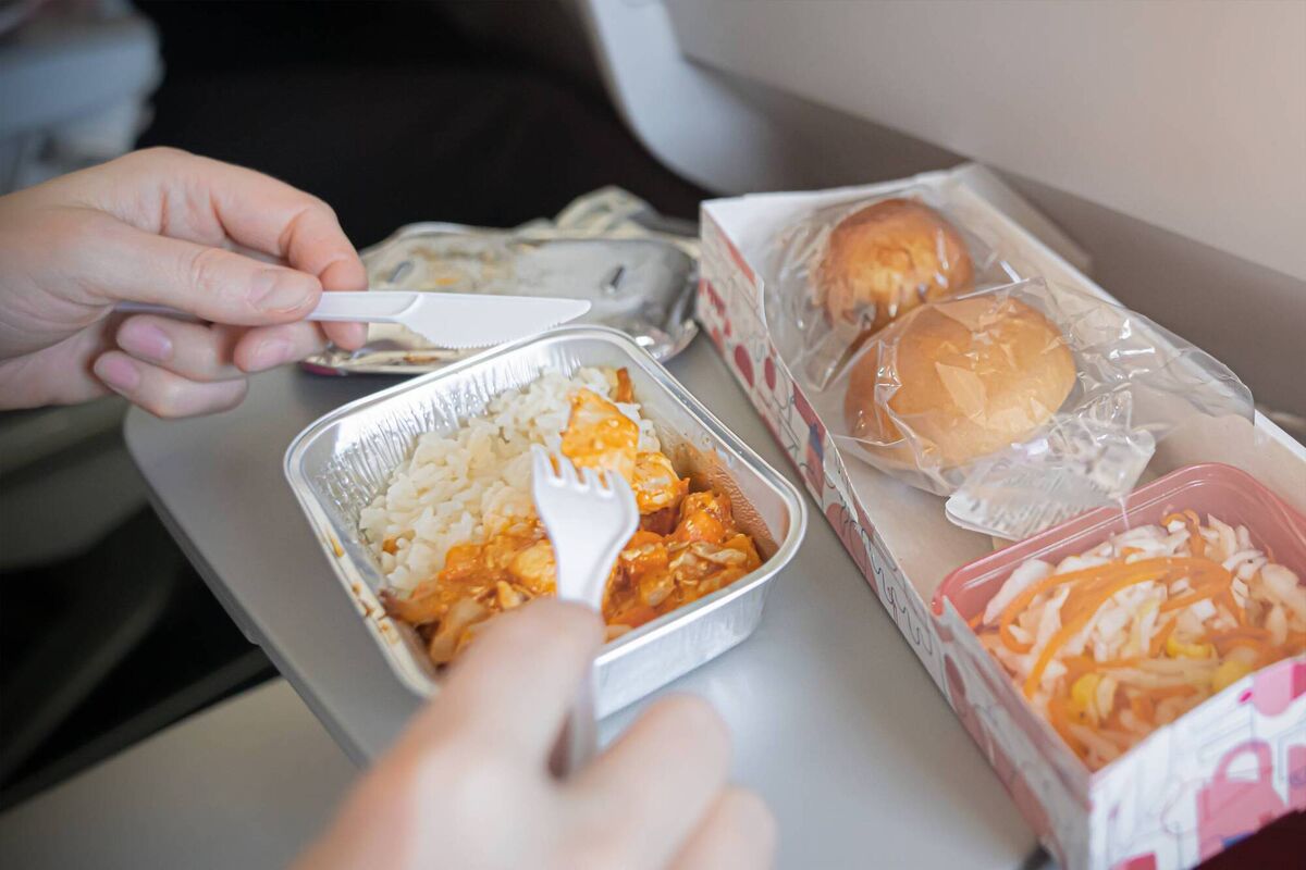 We should treat school meals like plane food, argues Jolene Cox, they need to be robust enough to handle transport and storage while warm until we have kitchens in schools. 