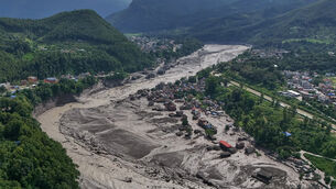 <p>Damaged houses stand near the swollen, debris-choked banks of the Trishuli River after flash floods in Nepal’s Nuwakot district (Niranjan Shrestha/AP)</p> <p>Damaged houses stand near the swollen, debris-choked banks of the Trishuli River after flash floods in Nepal’s Nuwakot district (Niranjan Shrestha/AP)</p>