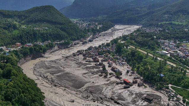 <p>Damaged houses near the swollen, debris-choked banks of the Trishuli River after flash floods in Nepal's Nuwakot district on Wednesday. Picture: Niranjan Shrestha/PA.</p>