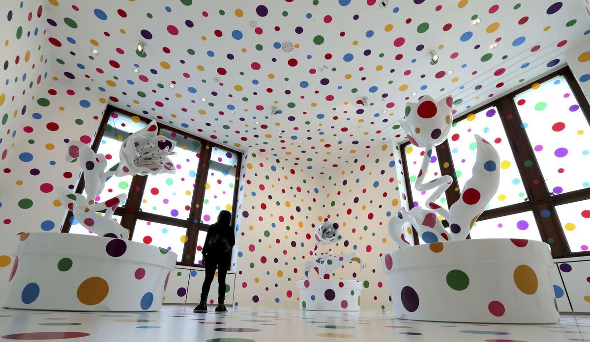 A woman looks at the artwork 'With All My Love For The Tulips, I Pray Forever' by artist Yayoi Kusama in Berlin, Germany, in 2019. Picture: AP Photo/Michael Sohn A woman looks at the artwork 'With All My Love For The Tulips, I Pray Forever' by artist Yayoi Kusama in Berlin, Germany, in 2019. Picture: AP Photo/Michael Sohn