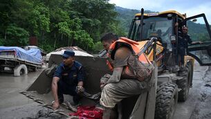 <p>Rescue personnel using an excavator to carry a person affected by flash floods at Devghat in Nepal's Nuwakot district. Picture: Prakash MATHEMA / AFP via Getty Images.</p> <p>Rescue personnel using an excavator to carry a person affected by flash floods at Devghat in Nepal's Nuwakot district. Picture: Prakash MATHEMA / AFP via Getty Images.</p>