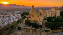 Aerial sunset panorama view of Cullera castle and popular seaside resort vacation town near Valencia Spain