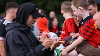 Jack Crowley signs an autograph for a young fan after the game 21/8/2026